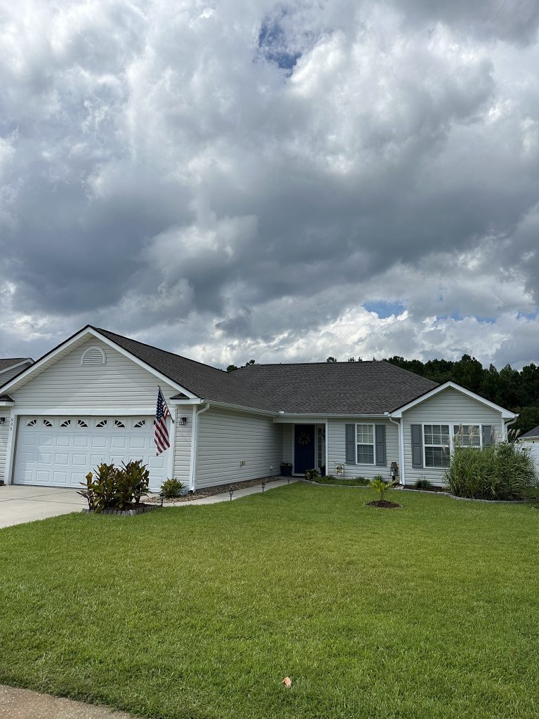 Single-story home with dark gray architectural shingle roof and two-car garage in Myrtle Beach, SC
