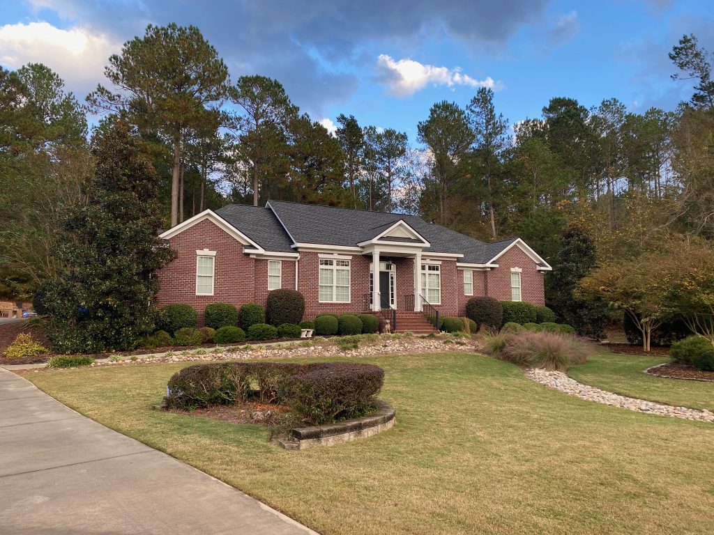 Two-story home with white trim and a newly installed dark shingle roof in Savannah, GA