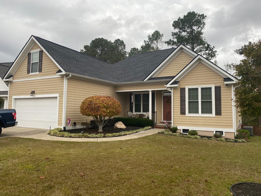 Brick ranch home with a new shingle roof and mature shade trees in Savannah, GA