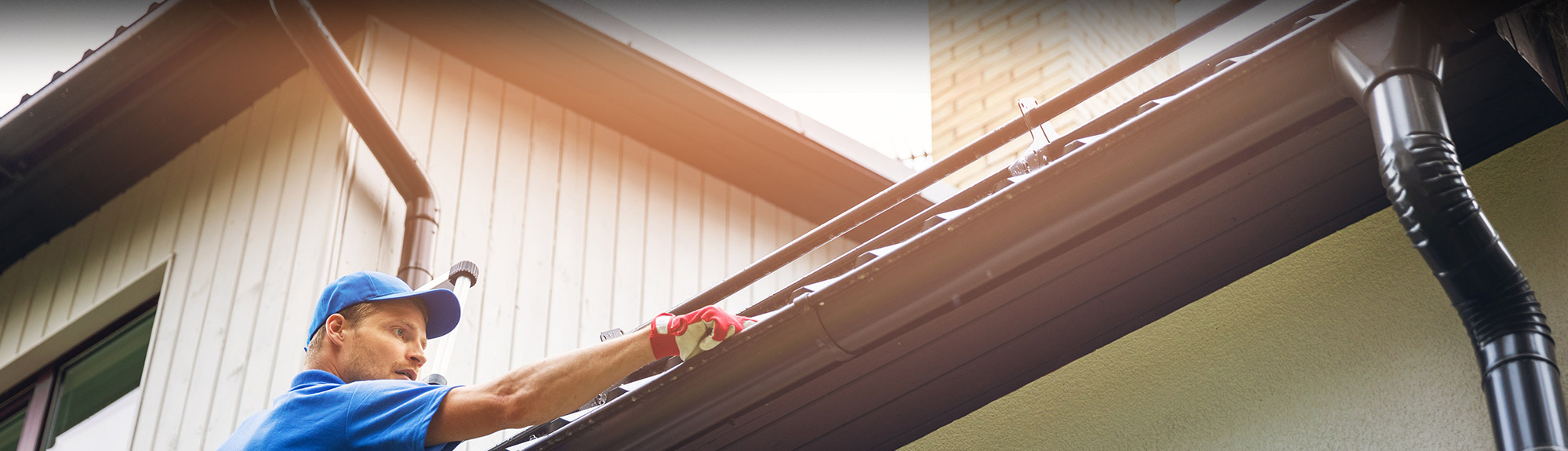 man installing gutters