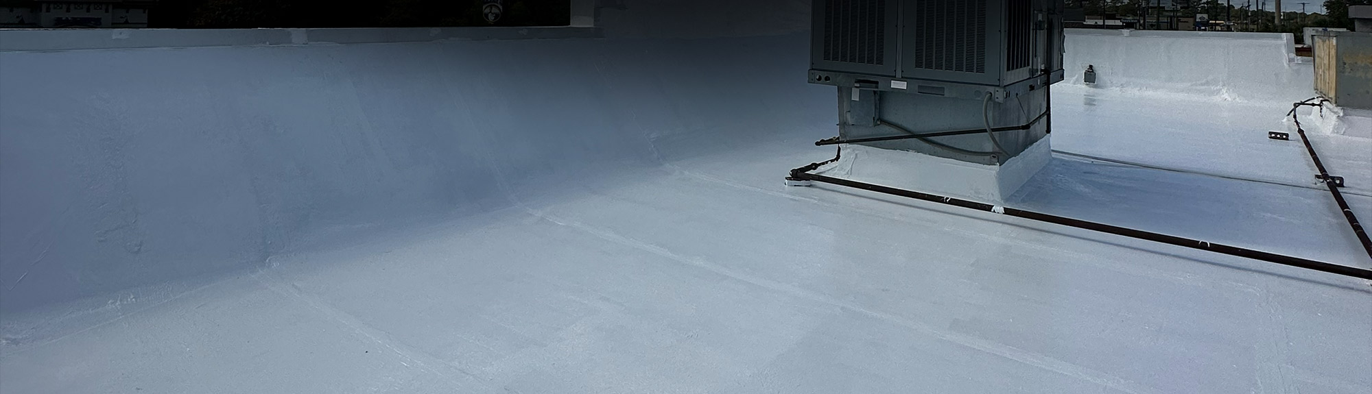 Waterproof roof coating applied around a rooftop HVAC unit on a commercial building in Jacksonville, FL